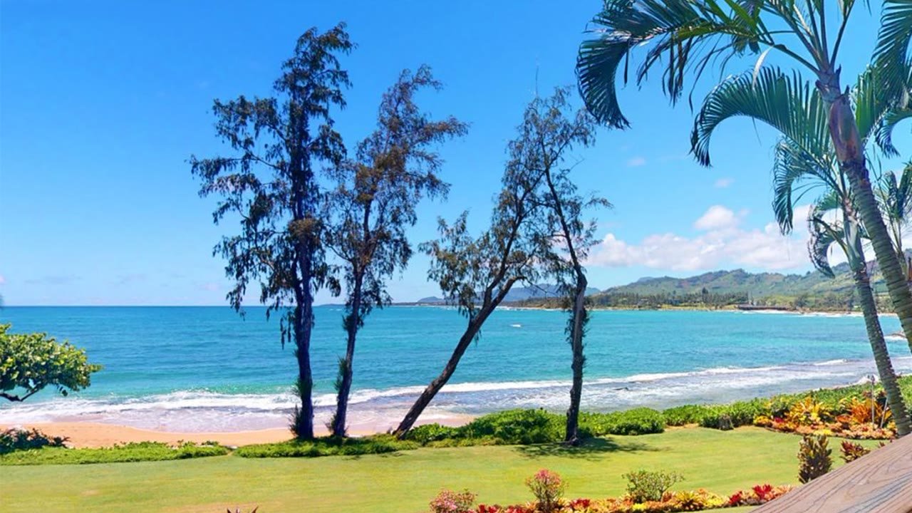 The sandy beach at Lae Nani and the sunset lanai at Wailua Bay View ~ Ron and Teri's two oceanfront Kauai condos in Kapaʻa.
